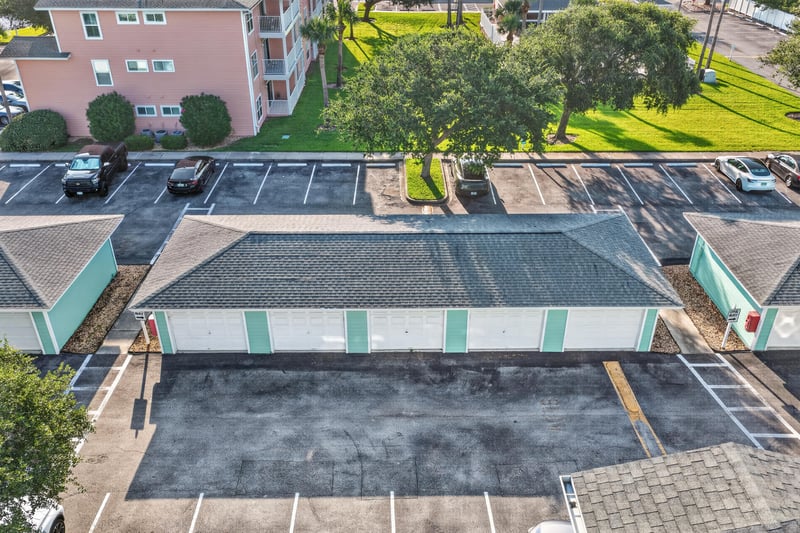 Aerial view of parking lot and nearby pink building rooftops in St. Augustine, FL