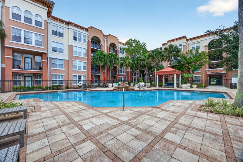 Front exterior of the condo building with courtyard pool at 10435 Mid Town Pkwy unit 135, Jacksonville, FL 32246