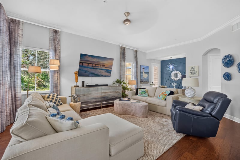 Living room with sectional seating and wall-mounted TV at 140 Ave De La Mer, Palm Coast, FL 32137