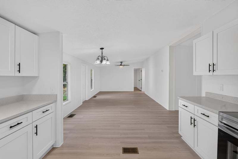 Kitchen view toward hallway with white cabinetry at 55520 Jewel-Thomas Rd, Callahan, FL 32011