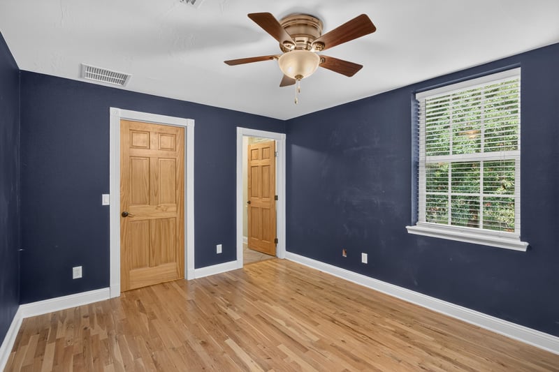 Bedroom with navy walls and multiple doors at 1735 Hagans Ridge Ct