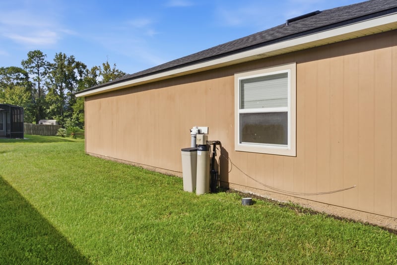 Side exterior with AC unit and lawn at 7392 Timber Falls Ct