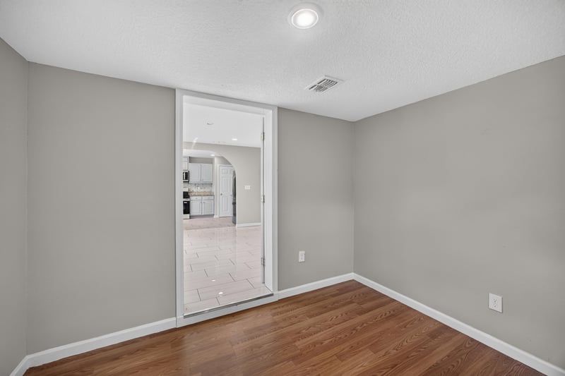 Hallway view toward kitchen at 7015 Miss Muffet Ln N, Jacksonville, FL 32210