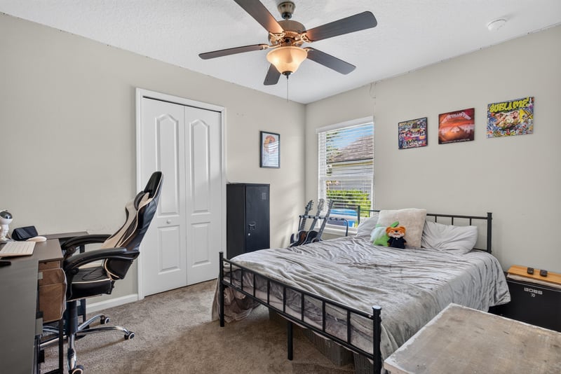 Bedroom with desk and ceiling fan at 589 Seville Pkwy, St. Augustine, FL
