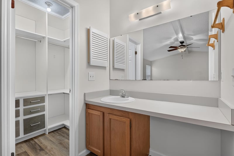 Bathroom with dual-sink vanity and walk-in closet at 4427 Millstone Ct, Jacksonville, FL