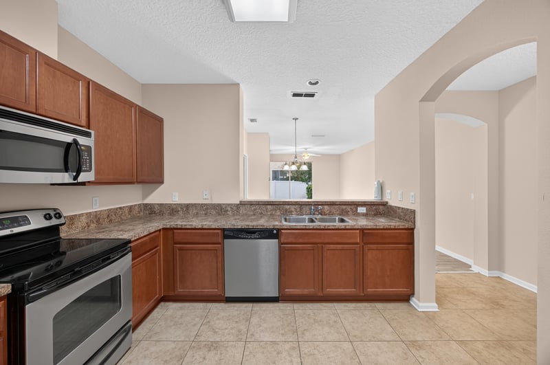Kitchen range and wood cabinets at 3762 Hartsfield Forest Cir, Jacksonville, FL 32277