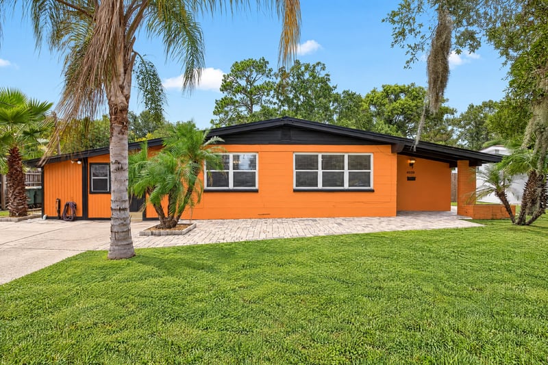 Front exterior, orange house and palm trees at 4039 Habana Ave, Jacksonville, FL