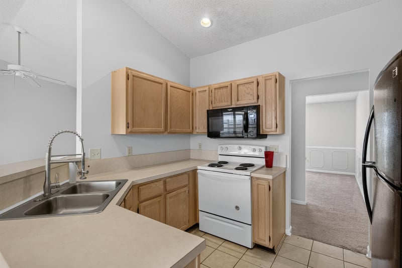 Kitchen sink with white range and cabinets at 400 Ashcroft Landing Dr, Jacksonville, FL 32225