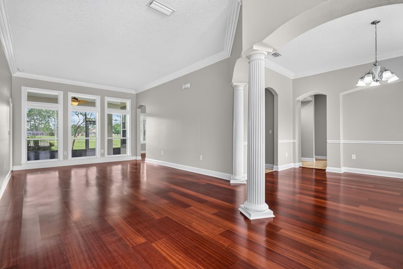 Foyer with columns, arched doorway and wood floors at 4109 Eagle Landing Pkwy, Orange Park, FL 32065