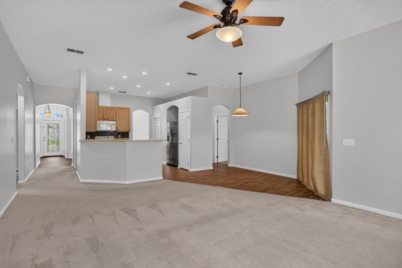 Open living area with view toward kitchen arches at 2480 Ridge Will Dr, Jacksonville, FL 32246