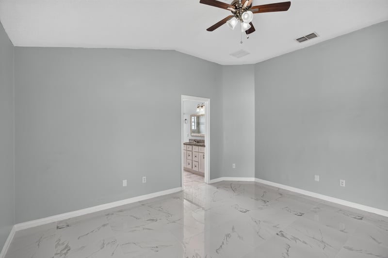 Bedroom with ceiling fan and doorway to bath at 490 Hillside Dr, Orange Park, FL 32073