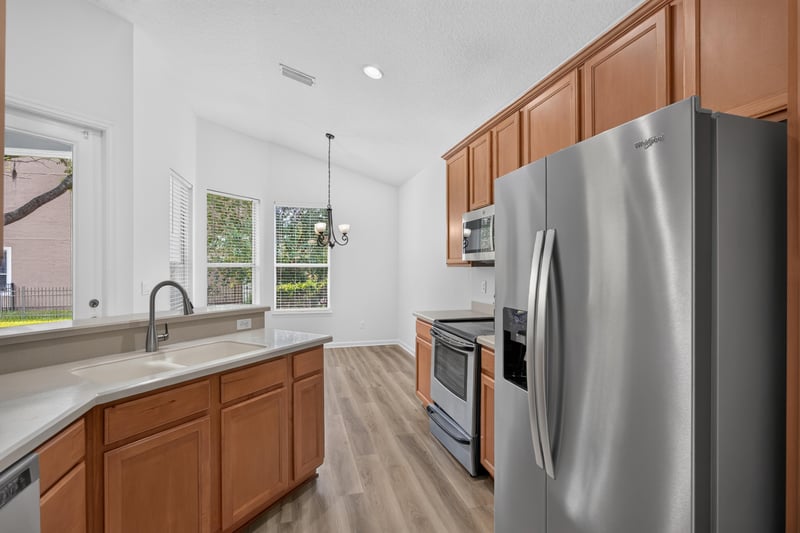 Kitchen with refrigerator and wood cabinets at 3101 E Banister Rd, St. Augustine, FL 32092