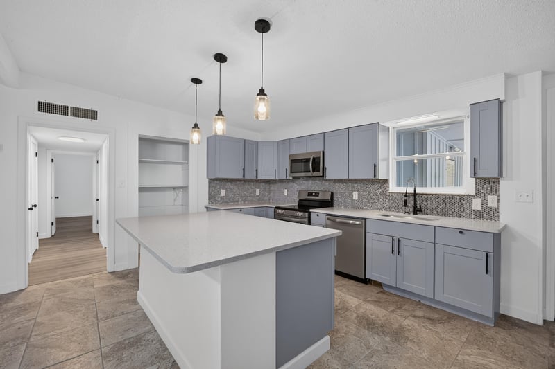 Kitchen view toward hallway with gray cabinetry at 3113 Kline Rd, Jacksonville, FL 32246
