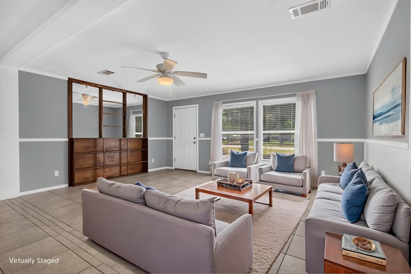 Living room with tile floor and wood-framed pass-through windows at 2549 Snapdragon Ave, Middleburg, FL 32068