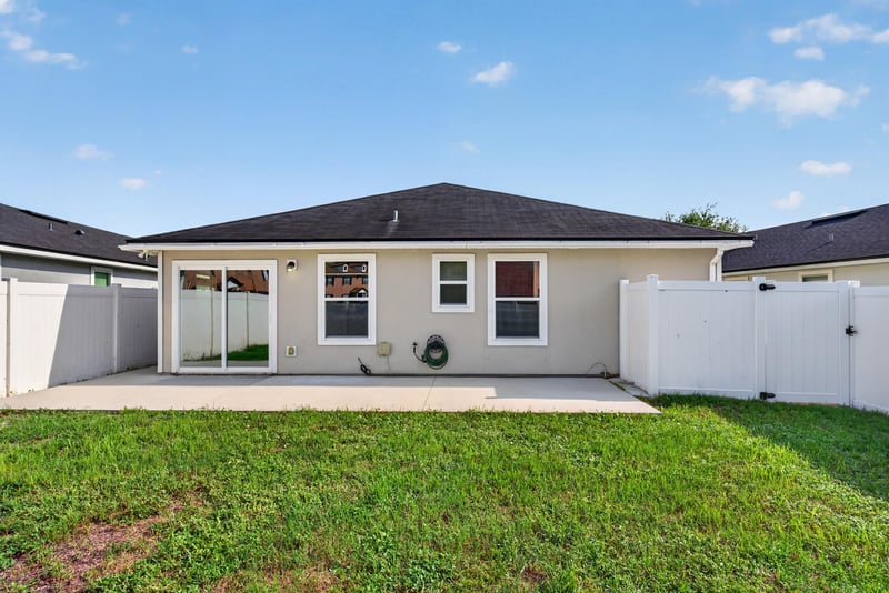Backyard patio with vinyl fence at 7253 Townsend Village Ct, Jacksonville, FL