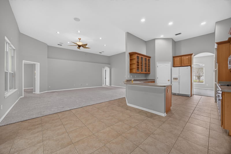 Kitchen open to family room with ceiling fan at 635 Wakeview Dr, Orange Park, FL 32065