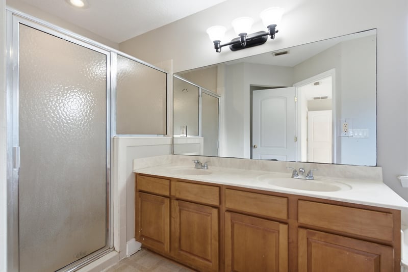 Bathroom with glass shower and vanity mirror at 14187 Big Spring St, Jacksonville, FL 32258