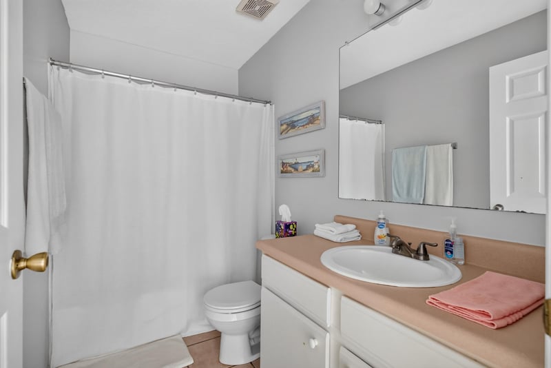 Second bathroom with sink and shower curtain at 206 16th St, St. Augustine, FL 32080