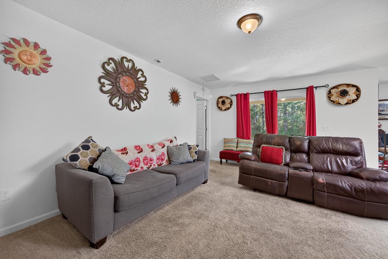 Living room view toward kitchen pass-through at 518 Matecumbe Ct, Macclenny, FL