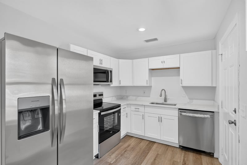 Kitchen with stainless appliances and tile backsplash at 855 Cornwallis Dr, Jacksonville, FL