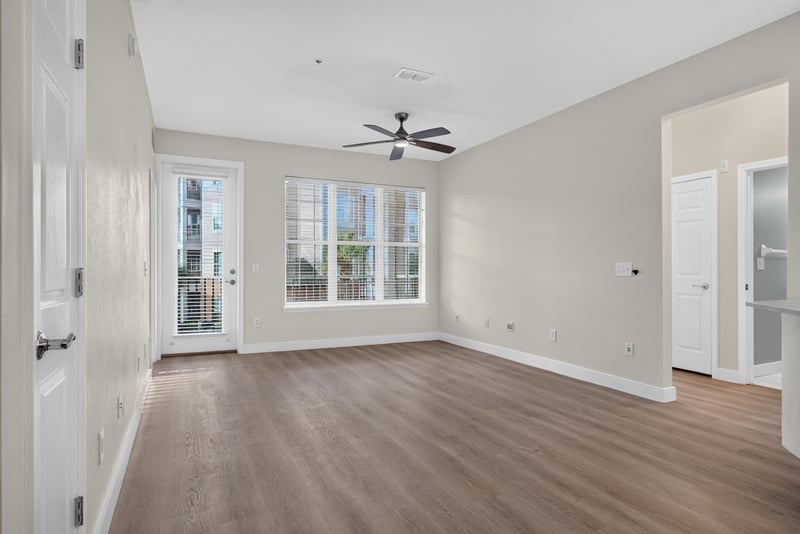 Living room with large window and ceiling fan at 11251 Campfield Dr unit 1202, Jacksonville, FL 32256