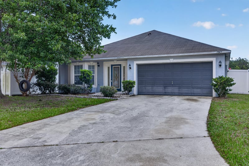 Front exterior with driveway and entry door at 1845 Saga Ct, Middleburg, FL