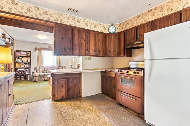 Kitchen with wood paneling and white refrigerator at 1807 Idlewild Ave, Green Cove Springs, FL