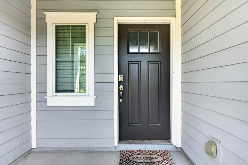 Front door with glass sidelight and welcome mat at 339 Anthony Dr, Jacksonville, FL