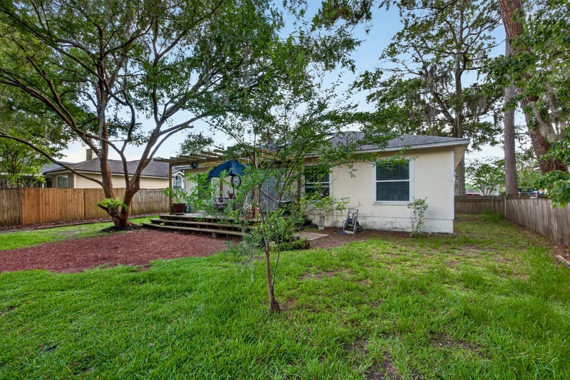 Backyard lawn with trees and fence at 145 Dover Bluff Dr, Orange Park, FL