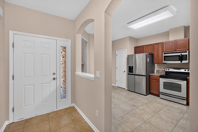 Tiled entry hall leading toward kitchen at 3762 Hartsfield Forest Cir, Jacksonville, FL 32277