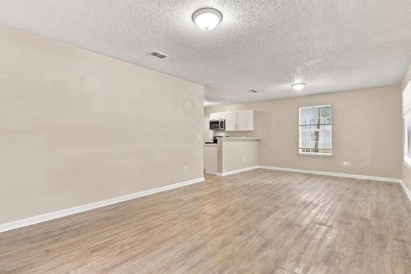 Open living area with wood floors leading to kitchen at 219 Shortreed St, Jacksonville, FL 32254