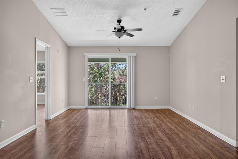 Living room with ceiling fan and patio door at 7047 Deer Lodge Cir, Jacksonville