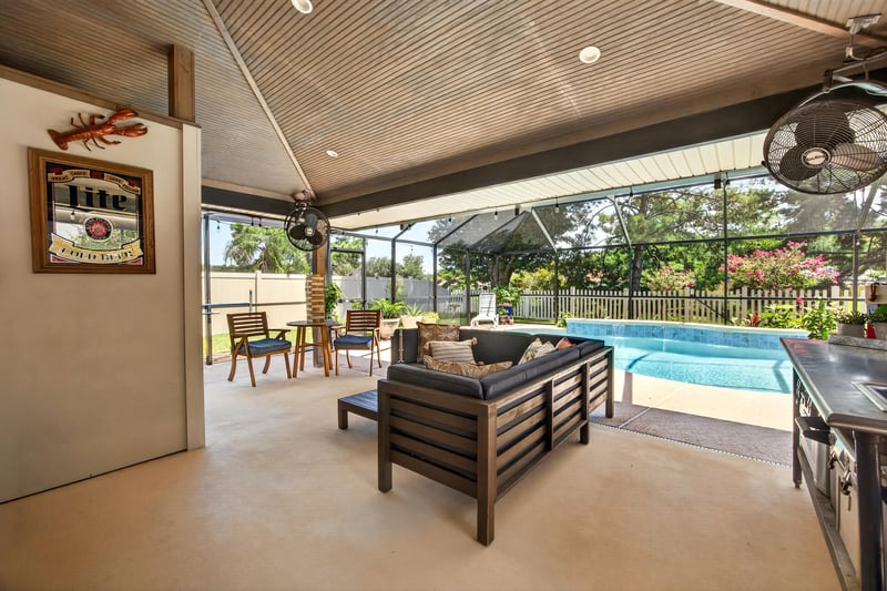 Covered patio with seating and pool at 1589 Backwater Drive, Middleburg, FL 32068