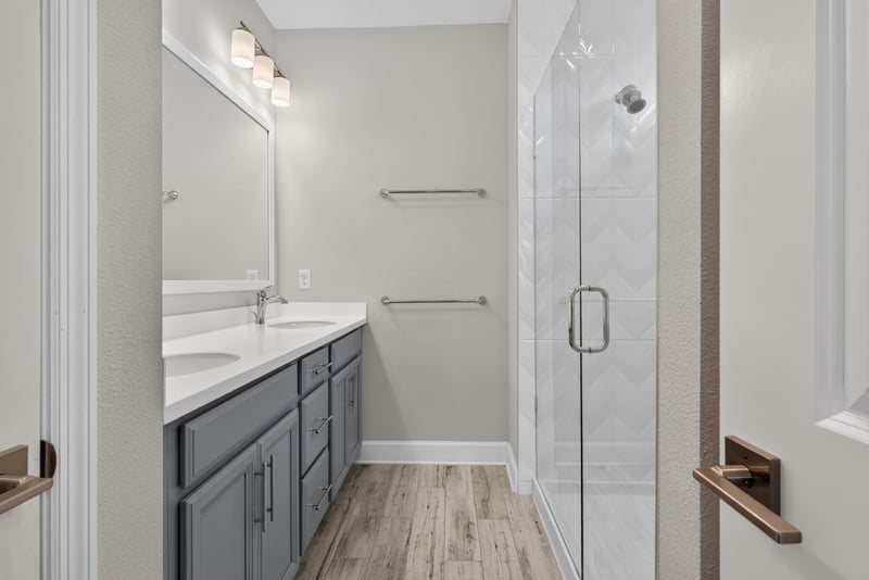 Bathroom with dual vanity and glass shower at 7446 Loggerhead Ct, Jacksonville, FL 32256