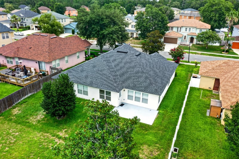 Aerial view of the home's roof and backyard in Adams Lake, Jacksonville, FL