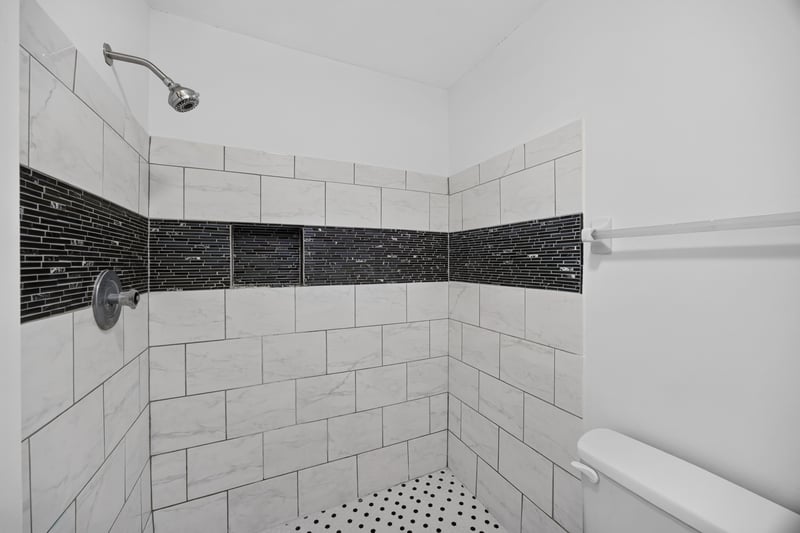 Shower with tile and black accent stripe at 3801 Crown Point Rd unit 2061, Jacksonville, FL 32257