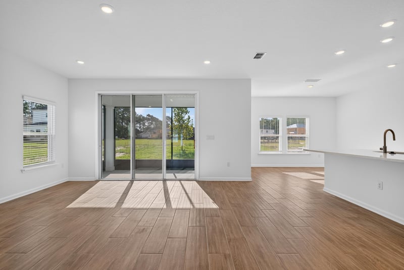 Living area with sliding glass doors to backyard at 269 Bluegrass Wy, St. Augustine, FL 32092