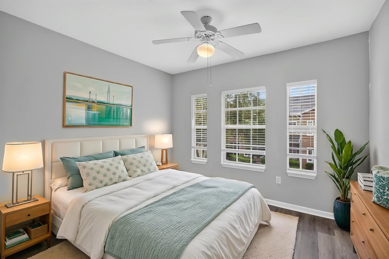 Virtually staged bedroom with bed and nightstands at 10075 Gate Pkwy unit 1905, Jacksonville, FL 32246