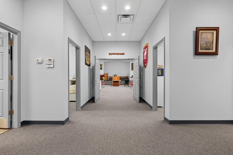 Hallway with white walls and carpet leading to interior doors at 1038 County Rd 315, Melrose