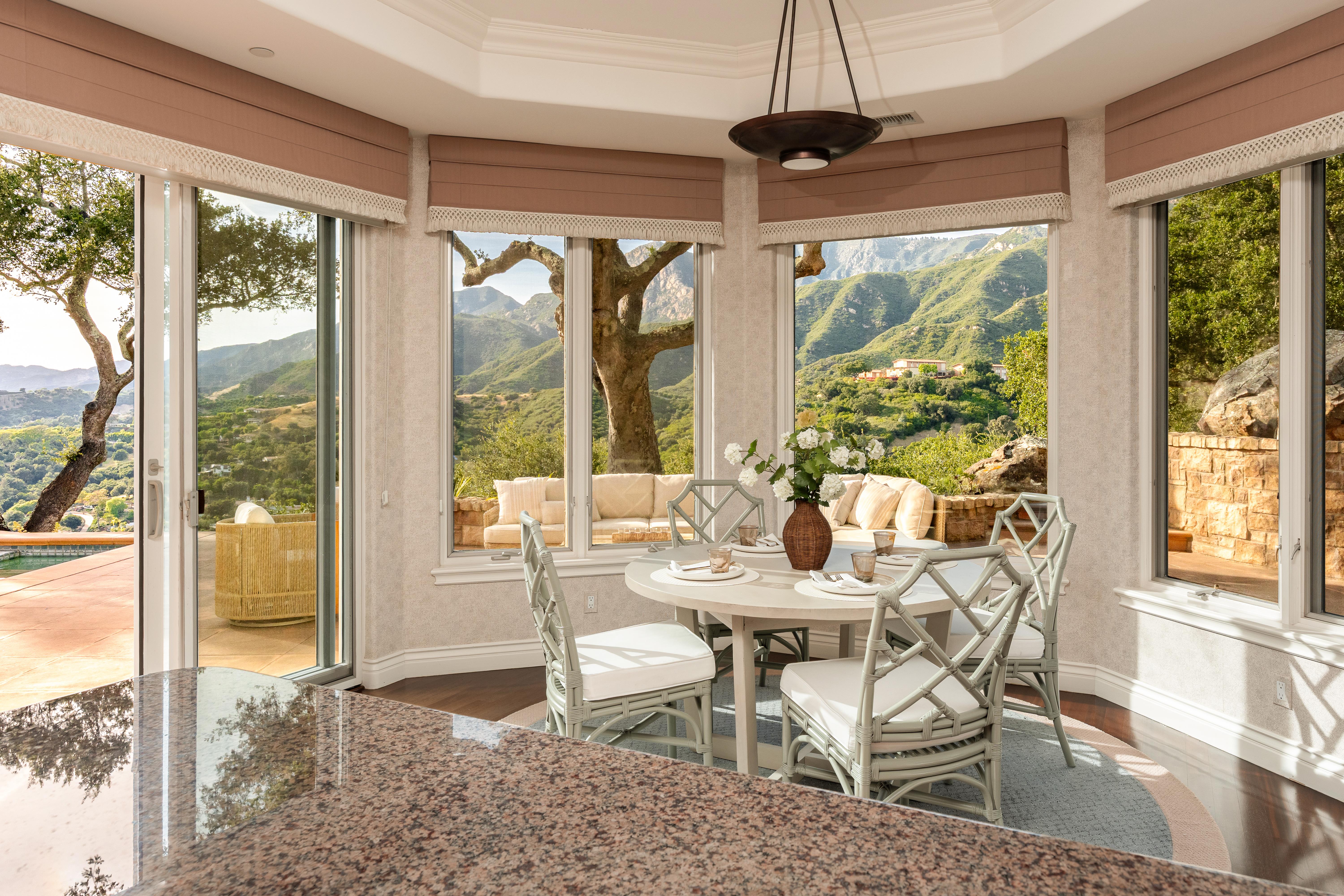 Twilight photography of estate exterior at 450 El Cielito Rd, Santa Barbara — virtual tour photography and twilight imaging capturing warm interior light against a violet Pacific sky above the American Riviera. Our team captured still photography, aerial drone photography, twilight photography, a Matterport virtual tour, a 2D floor plan, and a custom property website from afternoon through twilight.