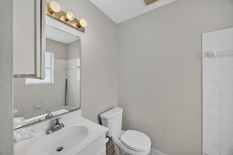 Bathroom with pedestal sink and tiled walls at 2658 Trollie Ln apt 1, Jacksonville, FL 32211