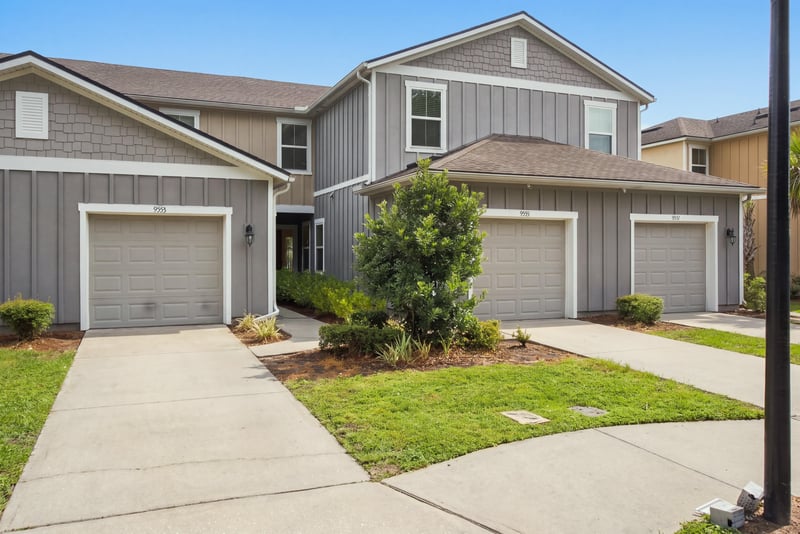 Driveway and garage with landscaping at 9555 Star Dr, Jacksonville, FL 32256