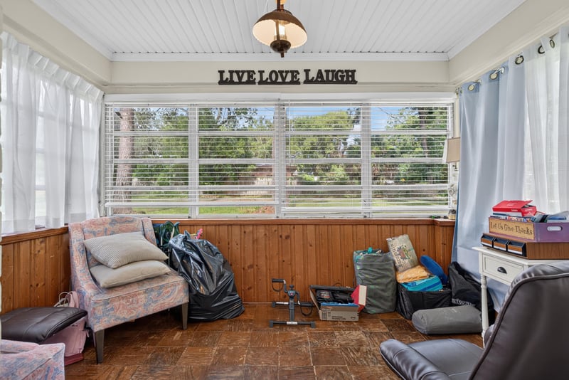 Enclosed porch with windows and seating at 5745 110th St, Jacksonville, FL 32244