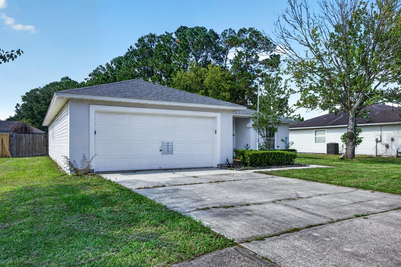 Close view of garage door and driveway at 9691 Nelson Forks Dr, Jacksonville, FL 32222