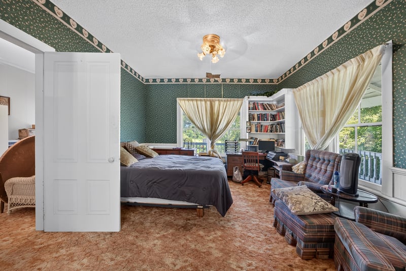 Bedroom with bookshelves and leather chairs at 1173 US-17, Satsuma, FL 32189