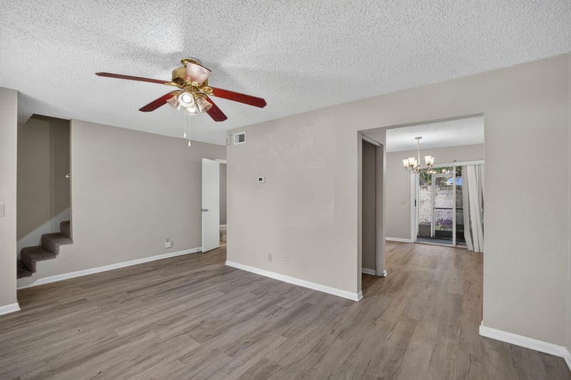 Living room with staircase and view toward the kitchen at 2658 Trollie Ln apt 1, Jacksonville, FL 32211
