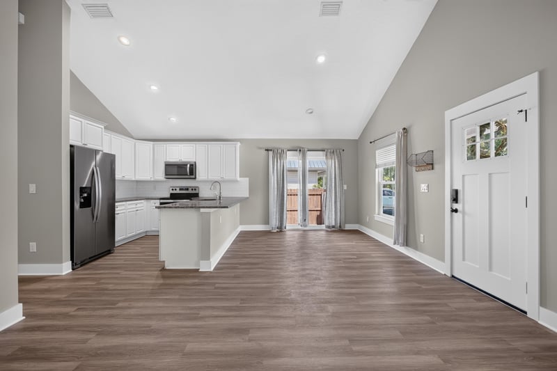 Living room with kitchen island and glass back door at 2855 N 8th St, St. Augustine, FL 32084