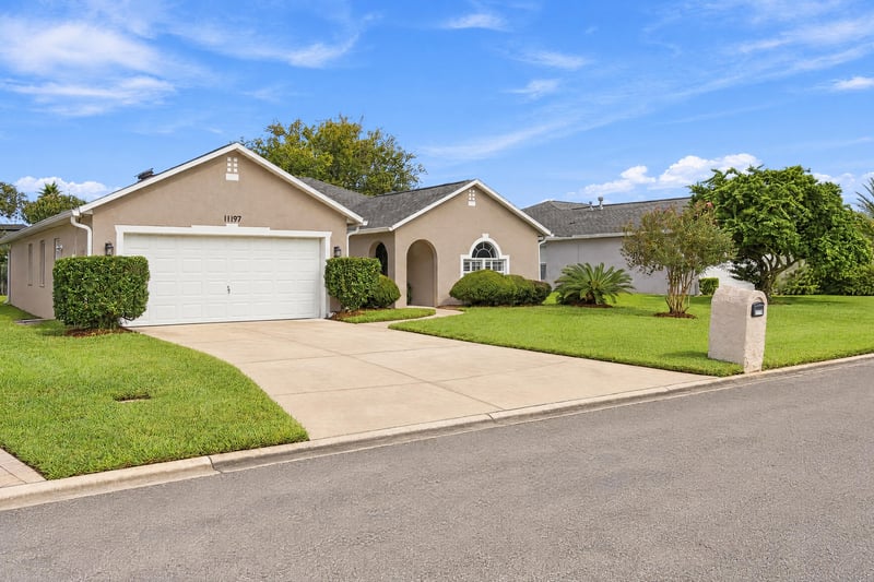 Front exterior view down tree-lined street at 11197 Illford Dr
