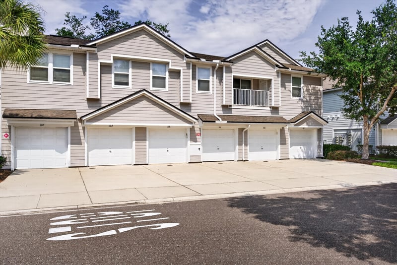 Front exterior of the townhome row with parking at 8196 Cabin Lake Cir, Jacksonville, FL 32256