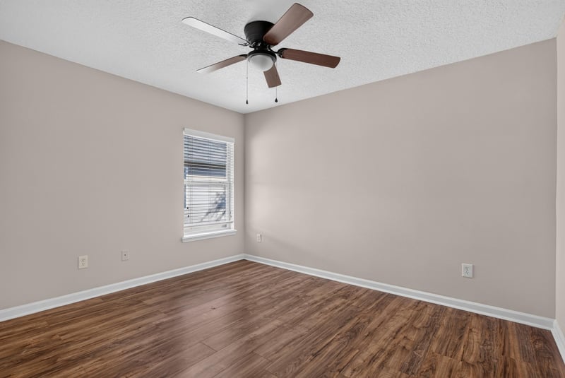 Bedroom with ceiling fan and window at 7047 Deer Lodge Cir, Jacksonville